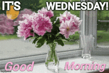 a bouquet of pink flowers in a vase with the words " it 's wednesday good morning "