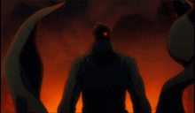 a silhouette of a man with a red eye standing in front of a fire