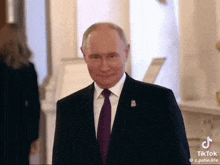 a man in a suit and tie is smiling for the camera .