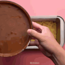 a person is pouring chocolate sauce into a loaf pan with the words mr.cakes on the bottom
