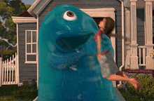 a girl is standing next to a blue monster with one eye