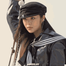 a woman wearing a hat and a jacket has the word wheeluv on the bottom