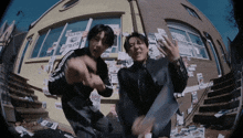 two men are dancing in front of a building that has a sign that says deal