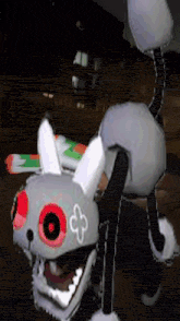 a stuffed animal that looks like a rabbit with red eyes