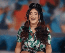 a woman in a camouflage shirt is smiling