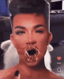 a close up of a person 's face with a heart in the bottom right corner
