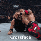 two wrestlers in a wrestling ring with the words crossface on the ground