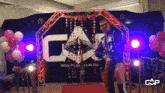 a wrestler is standing in front of a sign that says cap
