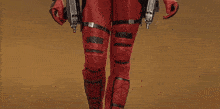 a woman in a deadpool costume holds two guns in her hands