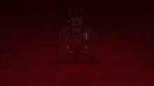 a robot is upside down in the dark with a yellow light behind it