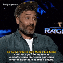 a man wearing a hat and a denim shirt is talking about a big break .