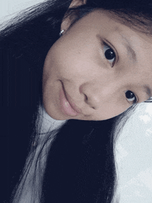 a close up of a girl 's face with her eyes closed