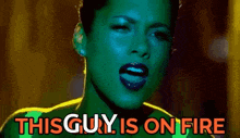 a woman with green skin is singing a song and the words `` this guy is on fire '' are visible .