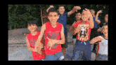 a group of young boys are standing next to each other dancing .