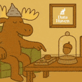 a moose is sitting in a chair in front of a sign that says " data haven "