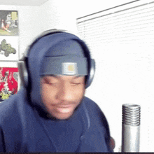 a man wearing headphones and a headband with the letter n on it