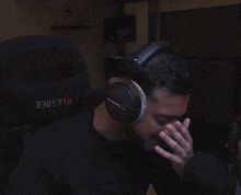 a man wearing headphones with the word leader on the back of his shirt