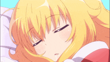 a girl with blonde hair and blue eyes laying down