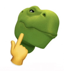 a hand is pointing at a green frog head
