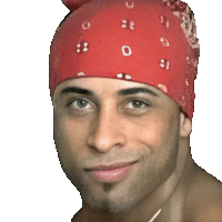 a man wearing a red bandana is smiling and looking at the camera .