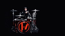 a blurred image of a man playing drums with a drum set that says zildjian