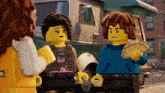 a couple of lego characters standing next to each other