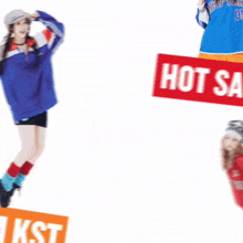a woman in a blue jacket is standing next to a red sign that says hot sale