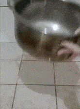 a person is washing their hands in a bowl