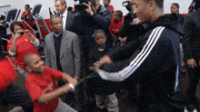 a boy wearing a red shirt that says ' united way ' on it is being photographed