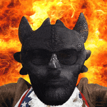 a man with a beard is wearing sunglasses and a pirate costume