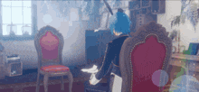 a blue haired anime character is sitting in a chair