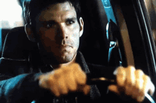 a man is driving a car with the number 31 on the side of the car