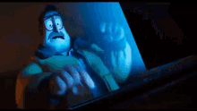 a close up of a cartoon character 's eyes with a blue light behind them .
