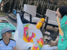 a woman is standing next to a unicorn float