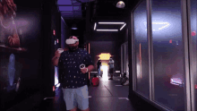 a man wearing a virtual reality headset walks down a dark hallway