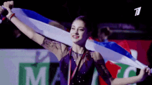 a woman in a purple dress is holding a flag in front of a sign that says " 1 "