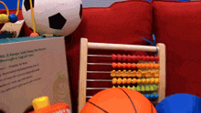 a box that says kids & keeps kids busy for hours sits next to a basketball and an abacus