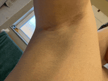 a close up of a woman 's underarm in a bathroom