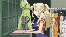 a woman is using a sewing machine in a room with clothes hanging on racks