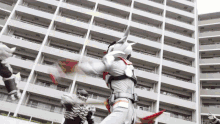 a man in a superhero costume is standing in front of a building