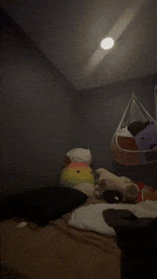 a bed with a rainbow stuffed animal on it
