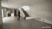 a woman is walking down a staircase in a room that says informal living or dining area on the wall