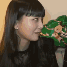 a close up of a woman 's face with a christmas hat behind her .