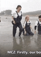 a group of people in overalls are kneeling in the water with the caption mc2 firstly our bo