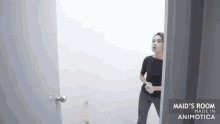 a woman standing in a room with the words maid 's room made in animonica