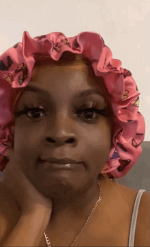 a woman wearing a pink satin bonnet with butterflies on it