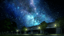a person stands under a starry night sky