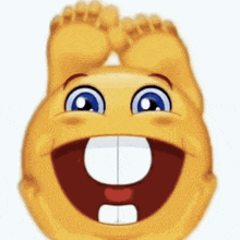 a smiley face is laughing with its feet up and a big smile on its face .