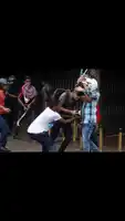 a man with blood on his face is being helped by a group of people