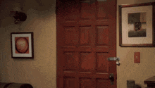 a man in a black shirt is walking through a doorway